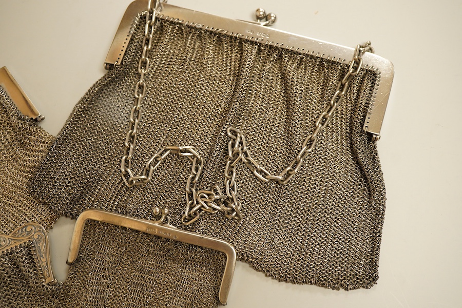 A George V silver mesh evening bag, import marks for Paul Ettlinger, London, 1932, a similar small evening purse, import marks for London, 1919 and two other white metal mesh evening bags or purses, one stamped sterling.